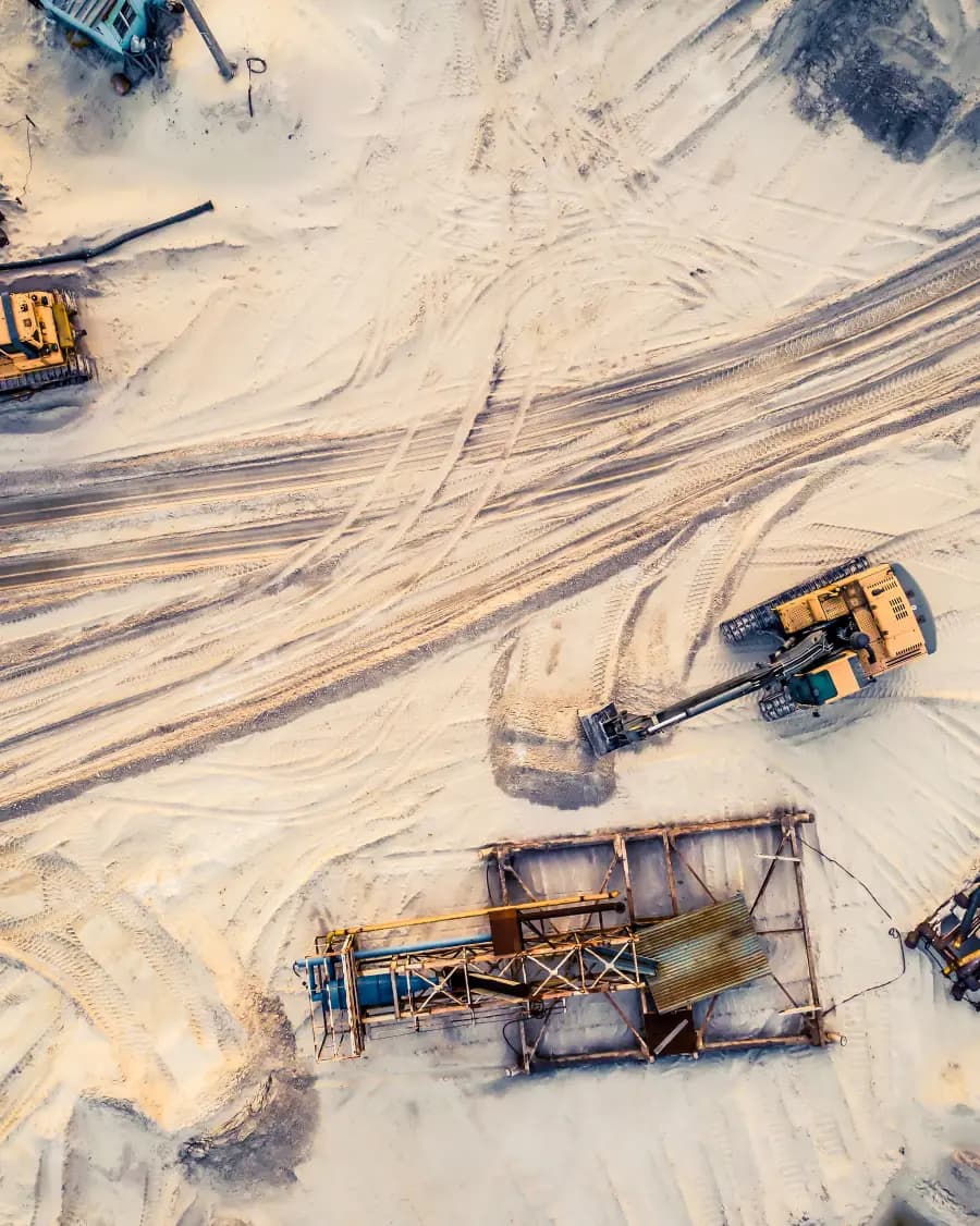 Aerial view of excavators and processing plant at an open-pit sand mine